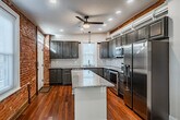 Kitchen w Exposed Brick - 251 Church St
