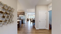 Located at 4000 Brookside Rd in Clarkston, Michigan, this thoughtfully designed single-story home offers a generous and functional floor plan with two bedrooms, two bathrooms, a dedicated office, and an attached garage. Rich hardwood-style flooring flows throughout the main living areas, connecting the open-concept kitchen, dining room, and living room in a seamless, inviting layout. The kitchen is highlighted by dark walnut cabinetry, white quartz countertops, stainless steel appliances, a herringbone tile backsplash, and ample storage. The adjacent dining area features a tray ceiling and pendant lighting, while the living room opens to views of the outdoors through large windows, filling the space with natural light. The spacious primary bedroom includes a tray ceiling, plush carpeting, and direct access to a well-appointed en-suite bathroom with a dual-sink vanity, dark wood cabinetry, and separate water closet. Abundant closet space is found throughout, with eight closets offering exceptional storage. The dedicated office provides a quiet retreat, and the laundry room adds everyday convenience. A patio extends the living space outdoors, and the attached garage offers additional utility and storage capacity.