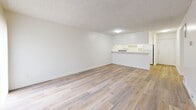 Located at 4550 N Figueroa St in the Highland Park neighborhood of Los Angeles, CA, this single-floor, 3-bedroom, 2-bathroom unit offers a practical and well-organized layout. Wood-look flooring runs throughout the space, providing a clean and cohesive aesthetic. Textured ceilings are consistent across all rooms, adding a classic residential character.

The open-concept living and dining area is bright and spacious, anchored by a sliding glass door with vertical blinds that allows generous natural light and outdoor access. The kitchen flows directly off this shared space and features white cabinetry, white countertops, a gas range with overhead ventilation, and a double sink — all finished in a clean, neutral palette.

Each of the three bedrooms offers comfortable dimensions, with the primary bedroom providing a generous footprint. Several bedrooms include sliding closet doors and access to natural light through large windows or sliding glass doors. The unit includes a total of six closets, ensuring ample storage throughout.

The two bathrooms are finished in white with wood-look flooring. One features a shower/tub combination, while the other offers a more compact layout with a vanity and mirror. Both maintain a clean and functional design. A hallway connects the bedrooms and bathrooms, contributing to an efficient and well-structured floor plan.