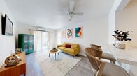 Located at 2116 N Garrett Ave in Dallas, TX, this efficiently designed one-bedroom, one-bathroom unit offers a smart, single-floor layout that maximizes every inch of its intimate footprint. Light wood-style flooring runs throughout, unifying the living spaces with a clean, contemporary feel.

The bright living room serves as the heart of the unit, featuring a ceiling fan, recessed lighting, a wall-mounted mini-split system, and sliding glass doors that invite natural light and provide access to the outdoors. The open layout flows seamlessly into the kitchen, which is connected via a built-in pass-through bar with seating — an efficient and stylish detail that enhances the social feel of the space.

The kitchen is equipped with stainless steel appliances, including a range and overhead microwave, and features dark wood cabinetry for added contrast. A dedicated laundry area adds everyday convenience.

The bedroom is a cozy, well-appointed retreat with light walls, wood-style flooring, and a closet. The full bathroom includes a tub-shower combination with large-format grey tile surround, a dark wood vanity, and wood flooring, offering a clean and functional design. This unit delivers practical urban living in the heart of East Dallas.