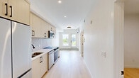Located in the sought-after community of Bankview in SW Calgary, this thoughtfully designed two-bedroom, one-bathroom unit offers a clean, modern aesthetic throughout. Light-toned hardwood flooring flows seamlessly across the entire floor plan, complementing the bright white walls and creating a cohesive, contemporary feel.

The kitchen is well-appointed with flat-panel cabinetry in a warm natural wood finish, stainless steel appliances including a French door refrigerator, electric range, dishwasher, and over-the-range microwave, along with a stone tile backsplash and crisp white countertops. The space is efficient and functional, ideal for everyday living.

Both bedrooms are bright and airy, featuring large windows that invite natural light and baseboard heating for year-round comfort. The clean, minimalist design of each room provides a versatile canvas for personalization.

The full bathroom features large-format tile, a combined tub and shower with a sliding glass enclosure, and black hardware accents that add a modern touch.

A standout feature of this unit is the private balcony with glass railing, offering sweeping views of the Calgary downtown skyline framed by lush tree canopies — an exceptional outdoor retreat for any resident.