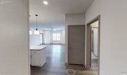 Located on Third Ave S in Birmingham, Alabama, this well-appointed single-floor residence offers a thoughtfully designed open-concept layout with modern finishes throughout. The kitchen serves as the heart of the home, showcasing crisp white shaker cabinetry extending to the ceiling, granite countertops, a subway tile backsplash, stainless steel appliances including a side-by-side refrigerator, range, microwave, and dishwasher, and a central island with pendant lighting overhead. A dedicated in-unit laundry area is conveniently accessible just off the kitchen. The open living area flows naturally from the kitchen, featuring durable wood-look flooring, recessed lighting, a ceiling fan, and windows that invite natural light throughout the space. The bedrooms are carpeted for comfort and include ample natural light from large windows with views of the surrounding area, along with a spacious walk-in closet fitted with wire shelving. Two bathrooms serve the unit: one features a long vanity with granite countertops and a glass-enclosed walk-in shower, while the second offers a granite-topped vanity and a tiled tub-shower combination. Clean white walls, consistent trim details, and a neutral color palette give the entire space a fresh, move-in-ready appeal.