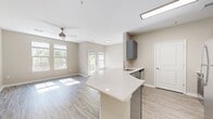 This contemporary 600 square foot apartment in Towson, MD offers a harmonious blend of style and functionality. The open-concept design maximizes the use of space, creating a seamless flow between the kitchen and living areas. Large windows throughout flood the rooms with natural light, enhancing the sense of spaciousness and connecting the interior with the outdoor greenery.

The apartment boasts high-quality finishes, including sleek grey-toned vinyl plank flooring that unifies the space and adds a modern touch. The kitchen features grey cabinetry, stainless steel appliances, and a white countertop, creating a clean and efficient cooking area. A ceiling fan in the main living space ensures comfort and air circulation.

The bedroom, measuring 130 square feet, provides ample space and includes a closet with wire shelving for organized storage. The bathroom is equipped with a shower/tub combination, a grey vanity, and a large mirror, maintaining the apartment's contemporary aesthetic.

Additional amenities include a hallway for easy navigation between rooms and a separate closet for extra storage. The apartment's neutral color palette, predominantly in soft beiges and greys, creates a calming atmosphere and serves as a blank canvas for personal decor.