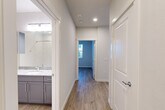 This well-appointed single-story home in Houston's 77007 corridor offers a thoughtfully designed layout with two bedrooms, two bathrooms, and a generous combined living and dining area. Light wood-look flooring flows consistently throughout the space, creating a clean, cohesive aesthetic. The open-concept living and dining room is bright and welcoming, with multiple large windows fitted with horizontal blinds that invite natural light and provide views of the surrounding neighborhood. Ceiling fans in each bedroom add comfort and a modern touch. The kitchen is outfitted with gray shaker-style cabinetry, granite-look countertops, a white subway tile backsplash, and stainless steel appliances including a side-by-side refrigerator. Both bathrooms feature gray vanity cabinetry with granite-look countertops and wood-look flooring. The primary bedroom is generously sized and connects to its own bathroom, offering a private retreat. Storage is abundant throughout, with five closets including a spacious walk-in closet equipped with wire shelving. A dedicated laundry area and utility room add everyday convenience. Recessed lighting and a neutral color palette unify the home's modern, move-in-ready interior.
