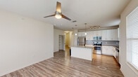Located at 16333 Columns Way in Baton Rouge, Louisiana, this single-story 2-bedroom, 2-bathroom home offers a thoughtfully designed floor plan with a comfortable, functional layout. The open-concept living and kitchen area is anchored by warm wood-look flooring, a ceiling fan, and abundant natural light from large windows and a glass door leading to the outdoors. The kitchen is well-equipped with white shaker cabinetry, granite countertops, a subway tile backsplash, a center island with pendant lighting, and a full suite of stainless steel appliances including a range, microwave, and dishwasher. Both bedrooms feature plush carpeting, ceiling fans, and dual windows with blinds that invite natural light. Each bedroom is served by a dedicated closet with built-in wire shelving. The two bathrooms mirror each other in finish quality, each offering granite-topped white vanities with undermount sinks, wood-look tile flooring, and a tiled soaking tub and shower combination. A hallway connects the bedrooms and bathrooms, and also provides access to a dedicated in-unit laundry closet. Two additional closets offer generous storage throughout the home. The overall aesthetic is clean, modern, and move-in ready.