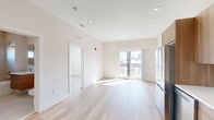 Located at 130 W Girard Ave in Philadelphia's vibrant Fishtown/Northern Liberties neighborhood, this 2-bedroom, 2-bathroom unit offers a thoughtfully designed, modern interior with a clean, contemporary aesthetic throughout. Light-toned hardwood flooring flows seamlessly across the entire unit, complementing the crisp white walls and recessed lighting overhead.

The open-concept kitchen and living area serves as the heart of the home. The kitchen features warm wood cabinetry extending to the ceiling, white quartz countertops, a white tile backsplash, and a full suite of stainless steel appliances including a French-door refrigerator, dishwasher, gas range, and built-in microwave. The living area is bright and airy, benefiting from a large sliding glass door that floods the space with natural light and provides views of the Philadelphia cityscape.

Both bedrooms are well-proportioned, featuring large windows with neighborhood views and continued hardwood flooring. The primary bedroom includes a double-door closet for ample storage, while a total of three closets are distributed throughout the unit. The two bathrooms are finished in a modern style with floating wood vanities, white countertops, large-format tile flooring, and a tub-shower combination in one. An in-unit laundry area adds everyday convenience to this polished urban residence.