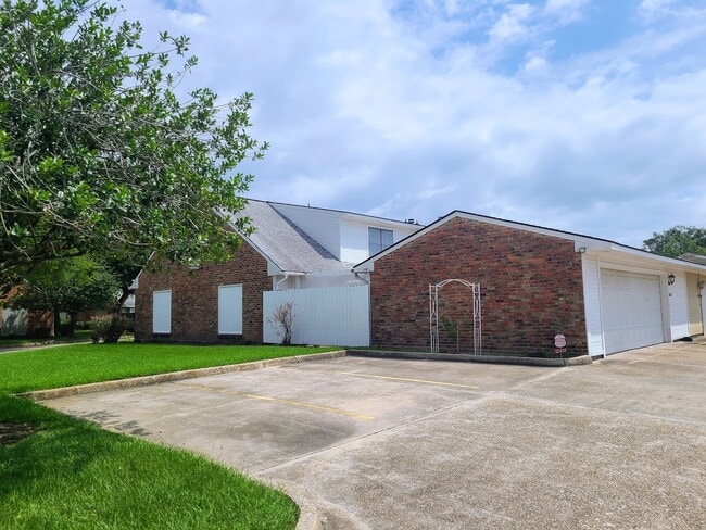 Side view of unit next to visitor parking. Half story windows of master bedroom. - 12439 Coursey Blvd