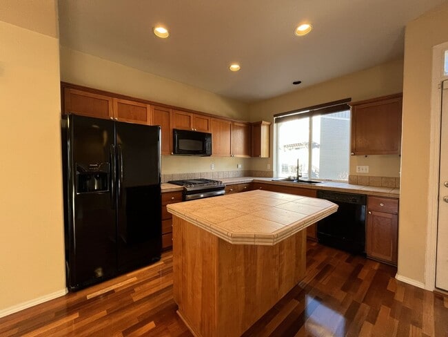 Building Photo - Thoughtfully Designed Three-Bedroom Home on a Corner Lot with Private Lower-Level Bedroom and Ens...