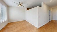 Located at 1300 Hendricks Ave in Jacksonville, FL, this one-bedroom, one-bathroom unit offers a practical and well-appointed layout across a single floor. The living area features warm hardwood flooring, crisp white walls, and a ceiling fan with integrated lighting, creating a bright and comfortable atmosphere. Natural light filters in through windows, enhancing the clean, open feel of the space. A hallway connects the main living area to the private quarters, providing a clear and functional flow throughout the unit. The bedroom is finished with plush carpeting and its own ceiling fan, offering a cozy and restful retreat. A spacious double-door closet provides ample storage, while a secondary door offers convenient access to the hallway. The bathroom is well-designed, featuring hardwood flooring, a tub-shower combination with elegant horizontal tile surround in neutral gray tones, a white vanity with granite countertops, and polished nickel fixtures. The consistent use of white millwork, neutral tones, and quality finishes throughout the unit contributes to a cohesive and modern aesthetic, making this Jacksonville residence a comfortable and functional living space.