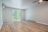 Located at 1624 Fordem Ave in Madison, Wisconsin, this 2-bedroom, 2-bathroom single-floor residence offers a well-organized layout designed for comfortable everyday living. The open-concept living and dining area is bright and welcoming, featuring light hardwood-style flooring, a ceiling fan with light fixture, baseboard heating, and a sliding glass door that leads to a private patio with views of the surrounding greenery. A wall-mounted mini-split unit provides additional climate control in the living space. The kitchen is equipped with rich warm-toned cabinetry, granite-style countertops, stainless steel appliances including a refrigerator, range, and microwave, and a peninsula that opens to the living and dining areas — ideal for casual entertaining. Both bedrooms are carpeted and include ceiling fans, natural light from windows, and access to ample closet space, with four closets distributed throughout the unit. The primary bedroom is generously sized and connects to a full bathroom featuring a wide vanity with warm wood cabinetry, a large mirror, and a tiled shower-tub combination. A second full bathroom with a tiled tub-shower is also available. A dedicated entrance and hallway provide a smooth transition into the main living areas of the home.