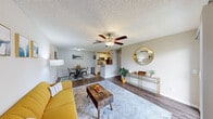 Located at 100 Powell Blvd in Daytona Beach, FL, this 2-bedroom, 2-bathroom single-floor residence offers a well-organized and functional layout. The open-concept living area features rich wood-look flooring, neutral-toned walls, and ceiling fans throughout, creating a comfortable and airy atmosphere. A sliding glass door in the living room floods the space with natural light and opens to a private patio with views of lush greenery. The living and dining areas flow seamlessly together, providing an efficient and inviting layout for everyday living.

The kitchen is equipped with stainless steel appliances, white cabinetry, and light granite-style countertops, including a peninsula with a built-in sink that offers additional workspace and casual dining potential. A dedicated laundry area is conveniently accessible within the unit.

Both bedrooms are carpeted and include ceiling fans and ample closet space. The primary bedroom features a walk-in closet with built-in shelving and a window with natural light. The second bedroom is well-sized and versatile. Each bathroom is clean and functional, featuring vanity lighting, a large mirror, and a shower-tub combination. Two dedicated closets provide additional storage throughout the home.