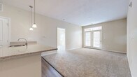 This 940 square foot apartment in Milford, OH offers a thoughtful blend of comfort and functionality. The space features two bedrooms, including a primary bedroom of 150 square feet, and two full bathrooms. The open-concept design creates a seamless flow between living areas, enhancing the sense of spaciousness.

Large windows in the bedrooms and living area flood the space with natural light, while providing views of the surrounding area. The rooms are adorned with neutral-toned walls and plush carpeting, creating a warm and inviting atmosphere. The modern kitchen boasts wooden cabinetry, stainless steel appliances, and a convenient breakfast bar, perfect for casual dining or entertaining.

The bathrooms are well-appointed, featuring frosted glass shower doors for privacy and wood-look flooring that adds a touch of warmth. Ample closet space in the bedrooms and a separate utility room offer practical storage solutions. The apartment's single-floor layout ensures easy accessibility throughout.

Overall, this apartment combines contemporary design with practical amenities, creating an ideal living space for those seeking comfort and convenience in a prime Milford location.