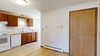 Located at 2721 Humboldt Rd in Green Bay, Wisconsin, this 2-bedroom, 1-bathroom single-floor unit offers a functional and straightforward layout across a comfortable footprint. Light-toned hardwood-style flooring runs throughout, creating a clean and cohesive look from room to room.

The kitchen is well-appointed with warm oak cabinetry, white appliances including a refrigerator, electric range, and dishwasher, plus a double sink and ample counter space. Pendant lighting accents the kitchen area, adding a subtle decorative touch. The kitchen flows naturally into the dining room, making everyday living convenient.

The family room is generously sized and connects seamlessly to the hallway, which leads to both bedrooms. The primary bedroom offers a comfortable amount of space, while the second bedroom features a window with vertical blinds, allowing natural light to filter in. Both bedrooms benefit from dedicated closet space, and the unit includes a total of four closets, providing ample storage throughout.

The bathroom features a full tub and shower combination with clean white surround. Baseboard heaters are present in multiple rooms, ensuring efficient heating during Wisconsin winters. The overall ambiance is clean, bright, and move-in ready.