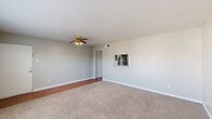 Located on Bissonnet Street in Houston, TX, this well-organized one-bedroom, one-bathroom home makes smart use of its single-story layout. The combined living and dining area serves as the heart of the home, featuring neutral gray walls, plush carpet flooring, and a ceiling fan with integrated lighting. A pass-through window connects the living space to the kitchen, enhancing the open feel. Hardwood-style flooring flows through the kitchen, which is outfitted with gray cabinetry, granite-look countertops, a stainless steel refrigerator, an electric range, a stainless sink, and a classic white subway tile backsplash. A dedicated pantry provides additional storage just off the kitchen. The spacious bedroom is carpeted and includes its own ceiling fan, a large window with blinds that invites natural light, and direct access to a generously sized walk-in closet complete with built-in shelving and hanging rods on multiple walls. The bathroom features a full tub-and-shower combo with white tile surround and a clean, bright finish. A hallway connects the main rooms, keeping the layout logical and easy to navigate. Clean finishes and neutral tones throughout give the home a move-in-ready appeal.