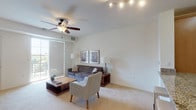 This single-floor residential unit offers a thoughtfully designed layout that balances comfort and functionality. The open-concept kitchen is a standout feature, equipped with stainless steel appliances including a refrigerator, gas range, and built-in microwave. Warm-toned wooden cabinetry pairs elegantly with granite countertops, which extend to a breakfast bar with seating — ideal for casual dining. Light tile flooring runs throughout the kitchen, adding a clean, polished look.

The living area is bright and welcoming, featuring soft carpeting, a ceiling fan, and a large sliding glass door that opens to a private balcony with outdoor views. Natural light fills the room, creating an airy and open atmosphere well-suited for relaxing or entertaining.

The bedroom is generously sized with plush carpeting, large windows with slatted blinds that allow abundant natural light, and convenient access to a walk-in closet. The room offers a calm, restful ambiance.

The bathroom maintains a crisp, clean aesthetic with light tile flooring, a white vanity with an integrated sink, a large mirror, and bright overhead lighting — delivering a practical yet tidy space. Overall, this unit presents a cohesive and comfortable living environment with modern finishes throughout.