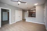Located at 5067 Elevated View in Chattanooga, Tennessee, this single-floor residence offers a thoughtfully designed open-concept layout with contemporary finishes throughout. Light wood-look flooring flows through the main living areas, complemented by neutral gray-toned walls that create a clean, modern aesthetic.

The living area is bright and welcoming, featuring a ceiling fan and a glass door that opens to an outdoor view, allowing natural light to fill the space. The kitchen is centrally positioned and features warm taupe cabinetry, granite countertops, a stainless steel refrigerator, and a stainless gas range. A peninsula with an undermount sink and pendant lighting above serves as both a functional workspace and a natural divider between the kitchen and living areas.

The bedrooms are carpeted for comfort, each equipped with a ceiling fan and windows with blinds offering views of the surrounding community. A walk-in closet is accessible from the main living area, adding generous storage.

The bathroom is designed with accessibility in mind, featuring grab bars throughout, a soaking tub with a handheld showerhead, a floating vanity with granite countertops, and a large mirror with overhead lighting. Light wood flooring continues into the bathroom, maintaining a cohesive look across the home.