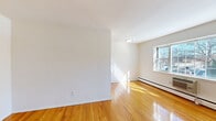 Located at 7 South Lake Drive in Hackensack, NJ, this one-bedroom, one-bathroom unit offers a well-organized single-floor layout designed for comfortable everyday living. Gleaming hardwood floors run throughout the entire space, lending warmth and a polished look to every room.

The combined kitchen and living area forms the heart of the unit, bathed in natural light from multiple windows that frame views of the surrounding neighborhood. Baseboard heating is present throughout, ensuring year-round comfort. A wall-mounted air conditioning unit provides additional climate control in the living area.

The bedroom is a well-proportioned private retreat, featuring its own window for natural light and a sliding closet door offering generous storage. In total, four closets are distributed throughout the unit, providing ample storage capacity that maximizes the efficiency of the floor plan.

The bathroom is finished with neutral large-format wall tiles surrounding a full tub-shower combination. A window above the tub allows for natural ventilation, while a white vanity with cabinet storage and tile flooring complete the clean, functional design.

White walls and flush-mount ceiling fixtures throughout maintain a bright, clean aesthetic. The layout flows logically from the entry through the living spaces to the bedroom and bath, making this a practical and comfortable unit in Hackensack's South Lake Drive neighborhood.