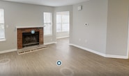 This single-story residence offers 760 square feet of thoughtfully designed living space. The home features three bedrooms, including a primary bedroom of 140 square feet, and one full bathroom. The heart of the home is a combined kitchen and living area, showcasing a brick fireplace as a focal point. The kitchen boasts white cabinetry, black appliances, and a practical L-shaped layout with a breakfast bar.

Throughout the home, wood-look flooring and light gray walls create a cohesive, contemporary aesthetic. Large windows with white plantation shutters allow ample natural light to flood the space. The bathroom is outfitted with a white vanity, tub-shower combination, and modern fixtures. A dedicated laundry room adds convenience to daily life.

Additional features include recessed lighting, ceiling fans, and ample closet space. The neutral color palette and updated finishes provide a move-in ready home with a fresh, modern feel. Despite its compact size, the efficient floor plan maximizes usable space, making this an ideal option for those seeking a low-maintenance yet comfortable living environment.