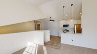 Located at 3686 Matador W in Traverse City, Michigan, this single-floor, 3-bedroom, 1-bathroom home offers a thoughtfully designed layout with clean, contemporary finishes throughout. The open-concept kitchen is a standout feature, showcasing vaulted ceilings that lend an airy sense of height, crisp white shaker cabinetry, light quartz countertops, and a peninsula with a built-in sink. Stainless steel appliances—including a range, microwave, and refrigerator—complement the space, while stylish pendant lights with glass shades and recessed lighting add a modern touch. Light wood-look vinyl flooring runs through the kitchen and main areas, transitioning to soft, neutral carpet in the living and bedroom spaces. The spacious primary bedroom benefits from abundant natural light and a ceiling fan, while the two additional bedrooms each feature windows with outdoor views, ceiling fans, and comfortable carpeting. The full bathroom is finished with a white tub-shower combination, wood-look flooring, a vanity with marble-style countertop, and matte black fixtures for a cohesive, modern aesthetic. A dedicated laundry room houses a full-size front-loading washer and dryer. Hallways connect the spaces efficiently, completing this well-appointed home.