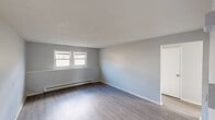 Located in Palmer, Massachusetts, this single-floor, 3-bedroom, 1-bathroom home offers a clean and updated interior designed for comfortable, everyday living. The layout includes a kitchen, hallway, closet, and three bedrooms, all thoughtfully arranged within a compact footprint.

The kitchen features white and grey shaker-style cabinetry with black hardware, a marble-look countertop, a single-basin sink with a matte black faucet, and a classic subway tile backsplash. A flush-mount light fixture and light wood-style vinyl flooring complete the space, which also includes a built-in baseboard heater.

The primary bedroom is the most spacious of the three, offering a generous layout with dual windows that allow natural light to fill the room. All bedrooms share neutral grey walls, light wood-style flooring, and baseboard heating, creating a consistent and cohesive aesthetic throughout.

The bathroom is neatly appointed with a grey shaker vanity, a white countertop, a full-size soaking tub, and marble-look surround wall panels that add a refined touch. Light wood-style flooring carries through here as well.

Throughout the home, soft grey walls, crisp white trim, and consistent flooring contribute to a clean, move-in-ready atmosphere suited for practical, comfortable living.