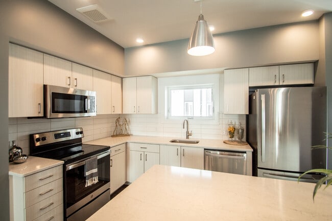 Kitchens with Stainless Steel Appliances - Juniper Rows at Deer Creek Apartments