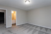 Located at 1755 20th Ave Dr NE in Hickory, NC, this single-floor, one-bedroom, one-bathroom unit offers a functional and well-organized layout. The main living area features durable hardwood-style flooring in a cool gray tone and a textured ceiling, creating a clean, neutral ambiance. A sliding glass door with vertical blinds opens to an outdoor patio, allowing natural light to fill the space and providing pleasant outdoor views.

The kitchen is efficiently designed in an L-shaped configuration, offering ample white cabinetry for storage, dark countertops, a single-basin sink, a white dishwasher, and a full-size refrigerator. The dark backsplash adds a subtle contrast to the bright white cabinetry. Hardwood-style flooring continues through the kitchen, complementing the rest of the main area.

The bedroom is a comfortable size, featuring soft wall-to-wall carpeting, neutral beige walls, and a large double window fitted with horizontal blinds that invite natural light while offering views of the surrounding neighborhood.

The bathroom is neatly appointed with wood-look tile flooring, a white vanity with ample counter space and storage below, a wall-mounted mirror, and a full shower-tub combination. Hallways connect the rooms, contributing to the unit's straightforward and practical flow throughout.