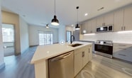 Step into a world of contemporary luxury at Aura - 349 in North Chesterfield. This exquisite 980 sq ft residence is a testament to modern living, offering a perfect balance of style, comfort, and functionality. The heart of the home is a chef's dream kitchen, boasting sleek cabinetry, subway tile backsplash, and a generous island illuminated by chic pendant lighting. Stainless steel appliances and ample counter space make meal preparation a joy.

The open-concept design creates a seamless flow between the kitchen and living areas, ideal for entertaining or relaxing. Large windows and sliding glass doors flood the space with natural light, leading to a private balcony where you can unwind and enjoy the view. The primary bedroom is a true retreat, spanning an impressive 370 sq ft and featuring plush carpeting for ultimate comfort.

Luxurious bathrooms showcase modern fixtures, spacious vanities, and glass-enclosed showers, providing a spa-like experience in your own home. With three full bathrooms, there's never a wait for your morning routine. The second bedroom offers versatility as a guest room, home office, or personal sanctuary.

Thoughtful details abound, from the energy-efficient ceiling fans to the sleek wood-look flooring throughout the main living areas. Ample closet space ensures organization is effortless. This turnkey property in the desirable Aura community represents the pinnacle of contemporary urban living. Don't miss this opportunity to elevate your lifestyle in a home that truly has it all.