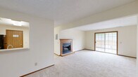 Located at 171 Applegrove St NE in North Canton, Ohio, this single-floor, 2-bedroom, 1-bathroom home offers a practical and comfortable layout. The open living room serves as the heart of the home, highlighted by a wood-mantled fireplace with a raised hearth and plush carpeting underfoot. A textured ceiling adds classic character throughout. Sliding glass doors lead directly from the living area to a private patio, bringing in natural light and outdoor access. The adjoining dining room flows seamlessly into the kitchen, which features cabinetry with warm wood tones and ample counter space. The primary bedroom is generously sized, offering a walk-in closet with dual shelving rods and additional storage, as well as a secondary closet with bi-fold wood doors. The second bedroom includes a window with views of the surrounding greenery. The full bathroom is finished with tile flooring, a single-sink vanity with a wide mirror, and a tub-shower combination. A dedicated laundry room and utility room add everyday convenience. With five closets throughout, storage is abundant. Neutral tones, consistent carpeting, and warm wood accents create a cohesive and move-in-ready atmosphere throughout the home.