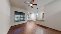 Located in the vibrant Montrose neighborhood of Houston, this well-appointed residence at City Place offers a thoughtfully designed single-story layout with four bedrooms and two bathrooms. The open-concept living and kitchen area immediately impresses with soaring ceilings, rich hardwood-style flooring, and a ceiling fan with light fixture that enhances the airy feel. Large windows fitted with blinds invite generous natural light and offer views of lush greenery outside. Track lighting and elegant pendant lights illuminate the kitchen, which features a granite-topped breakfast bar, dark cabinetry, stainless steel appliances, and a tile backsplash — combining style with functionality. An additional area near the entry showcases expansive windows and a glass door, further maximizing natural light throughout the home. The bedrooms are comfortably sized, finished with plush carpeting and ample window light. Closets are equipped with wire shelving systems, providing organized and practical storage. The bathrooms are finished with dark vanity cabinetry, light countertops, wide mirrors, and wood-look flooring. A connecting hallway adds to the smooth flow between living spaces, making this residence both functional and inviting.