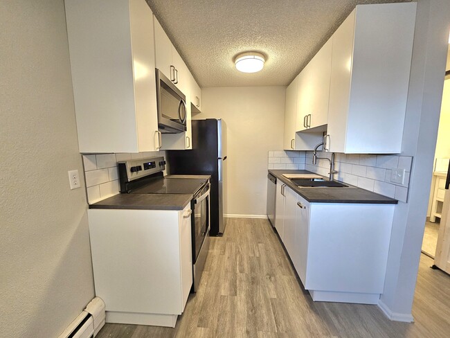 Kitchen with all of the amenities to bring out your inner chef with real-tile backplashes! - 12th and Wads Residences