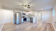 Located at 890 W Loveland Ave in Loveland, Ohio, this thoughtfully designed one-bedroom, two-bathroom residence makes excellent use of its single-floor layout. Light wood-style flooring flows seamlessly throughout, creating a cohesive and clean aesthetic across every room.

The kitchen is a standout feature, showcasing white shaker cabinetry, granite countertops, a classic subway tile backsplash, and a full suite of stainless steel appliances including a refrigerator, electric range, built-in microwave, and dishwasher. A ceiling fan with integrated lighting overhead enhances the open feel of the space where the kitchen connects to the living area.

The living room benefits from multiple windows that draw in natural light and offer outdoor views, further complemented by a ceiling fan. The bedroom, a comfortable and well-proportioned space, also features a ceiling fan and a window providing natural light and views to the exterior.

The bathrooms are finished with clean, modern detailing — one includes a full tub and shower combo with white subway tile surround and brushed gold hardware. Additional conveniences include three closets, a dedicated utility room, a hallway, and an entrance area, ensuring practical storage and functionality throughout. The neutral color palette and updated finishes give the entire space a fresh, move-in-ready appeal.