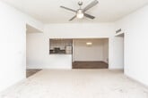 Located on Noble Creek Drive NW in Atlanta's 30318 zip code, this single-floor residence offers a thoughtfully updated interior with a mix of hard-surface and carpeted flooring throughout. The open living area is distinguished by vaulted ceilings and a ceiling fan, lending the space a generous, airy feel. Natural light filters in through multiple windows, offering views of surrounding greenery.

The kitchen is well-appointed with stainless steel appliances — including a gas range, microwave, dishwasher, and refrigerator — complemented by granite countertops, a tile backsplash, and ample cabinetry finished in a neutral tone. Wood-look flooring runs through the kitchen and adjoining areas, transitioning to plush carpet in the living and bedroom spaces.

The bathroom features a granite vanity countertop, a large mirror, wood-look tile flooring, and a tub-shower combination with decorative tile surround and glass enclosure. Bedrooms are carpeted and receive natural light through windows overlooking wooded surroundings. The entryway offers wood-look flooring and provides a clean transition into the main living areas, completing a cohesive and updated interior.