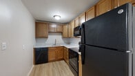 Located at 2555 Shoreline Dr. in Columbus, Ohio, this single-floor unit offers a practical and well-maintained layout designed for comfortable everyday living. The open-concept living and dining area features plush neutral carpeting that flows seamlessly toward the kitchen, which transitions to light-toned wood-look vinyl flooring. A window in the living area allows natural light to fill the space, creating a bright and welcoming atmosphere.

The kitchen is efficiently arranged in an L-shaped configuration and is equipped with warm-toned wooden cabinetry offering generous storage, light granite-patterned countertops, and a full suite of black appliances including a refrigerator, range, over-the-range microwave, and dishwasher. A stainless steel sink is centrally positioned beneath upper cabinets, completing the functional workspace.

The bedrooms are carpeted and receive natural light through windows fitted with blinds, offering a calm and comfortable retreat. Neutral wall tones throughout the unit lend a clean, move-in-ready aesthetic.

The bathroom is finished with light wood-look flooring and features a full tub-shower combination with a white surround, chrome fixtures, and a toilet, all set within a crisp, white-toned space. An electrical panel is accessible within the unit, and ceiling-mounted light fixtures provide consistent illumination throughout.