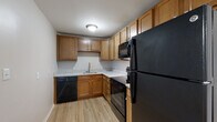 Located at 2555 Shoreline Dr. in Columbus, Ohio, this single-floor unit offers a practical and well-maintained layout designed for comfortable everyday living. The open-concept living and dining area features plush neutral carpeting that flows seamlessly toward the kitchen, which transitions to light-toned wood-look vinyl flooring. A window in the living area allows natural light to fill the space, creating a bright and welcoming atmosphere.

The kitchen is efficiently arranged in an L-shaped configuration and is equipped with warm-toned wooden cabinetry offering generous storage, light granite-patterned countertops, and a full suite of black appliances including a refrigerator, range, over-the-range microwave, and dishwasher. A stainless steel sink is centrally positioned beneath upper cabinets, completing the functional workspace.

The bedrooms are carpeted and receive natural light through windows fitted with blinds, offering a calm and comfortable retreat. Neutral wall tones throughout the unit lend a clean, move-in-ready aesthetic.

The bathroom is finished with light wood-look flooring and features a full tub-shower combination with a white surround, chrome fixtures, and a toilet, all set within a crisp, white-toned space. An electrical panel is accessible within the unit, and ceiling-mounted light fixtures provide consistent illumination throughout.