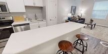 Step into a world of contemporary elegance and effortless living. This stunning apartment boasts a spacious 160 sq ft bedroom, offering a serene retreat after busy days. The open-concept kitchen and living area showcase gleaming stainless steel appliances, crisp white cabinetry, and chic subway tile backsplash, perfect for culinary enthusiasts and entertainers alike. Bask in the abundance of natural light flooding through large windows, while modern fixtures and warm wood-look flooring create an inviting ambiance throughout. The sleek bathroom and ample closet space add convenience to luxury. With its prime Irving location, this home isn't just a place to live—it's a lifestyle upgrade, where urban sophistication meets everyday comfort.