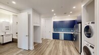 This thoughtfully designed one-bedroom, one-bathroom unit at 715 Park Ave in East Orange, NJ offers a fresh, modern aesthetic throughout. Light wood-look flooring flows seamlessly across every room, complemented by crisp white walls, clean baseboards, and recessed lighting that keeps the space feeling bright and well-appointed.

The open kitchen and living area serves as the heart of the unit, making a bold statement with deep navy blue cabinetry that extends floor to ceiling. A coordinating blue hexagonal tile backsplash adds texture, while stainless steel appliances — including a refrigerator, gas range, over-the-range microwave, and dishwasher — complete the functional, stylish setup. A stacked washer and dryer unit is conveniently integrated into the kitchen area, adding valuable in-unit laundry.

The bedroom is a calm, well-proportioned retreat featuring a window with outdoor views, a closet, and a wall-mounted mini-split system for individual climate control. The hallway connects the living spaces efficiently and includes additional storage.

The bathroom is finished with full-height white subway tile walls, large-format taupe floor and tub surround tiles, a sleek vanity with black metal accents, and a soaking tub with shower — delivering a clean, contemporary look with quality finishes throughout.