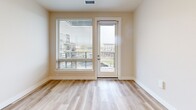 Located at 17270 W Colfax Ave in Golden, Colorado, this well-appointed one-bedroom, two-bathroom residence offers a thoughtfully designed single-level layout with a clean, contemporary aesthetic throughout. Light-toned luxury vinyl plank flooring runs seamlessly through the main living areas, complementing the neutral color palette that gives the space an airy, modern feel.

The open-concept kitchen and living area serves as the heart of the home. The kitchen is outfitted with warm wood-tone flat-panel cabinetry, white quartz countertops, stainless steel appliances including a full-size refrigerator, electric range, and over-the-range microwave, and a peninsula with a built-in sink — ideal for casual dining or meal prep. Recessed lighting illuminates the space efficiently.

The living area opens to a private balcony via a glass-paneled door, flanked by a large window with horizontal blinds that invite natural light and offer views of the surrounding community.

The bedroom features plush carpeting and a sizable window with outdoor views, creating a calm retreat. It connects to a well-sized closet and a full bathroom equipped with a tub-shower combination and light wood-look flooring. A second bathroom features a lengthy wood-tone vanity with dual sinks, white quartz countertops, and a large mirror, adding a touch of elegance to the home's functional design.