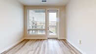 Located at 17270 W Colfax Ave in Golden, Colorado, this well-appointed one-bedroom, two-bathroom residence offers a thoughtfully designed single-level layout with a clean, contemporary aesthetic throughout. Light-toned luxury vinyl plank flooring runs seamlessly through the main living areas, complementing the neutral color palette that gives the space an airy, modern feel.

The open-concept kitchen and living area serves as the heart of the home. The kitchen is outfitted with warm wood-tone flat-panel cabinetry, white quartz countertops, stainless steel appliances including a full-size refrigerator, electric range, and over-the-range microwave, and a peninsula with a built-in sink — ideal for casual dining or meal prep. Recessed lighting illuminates the space efficiently.

The living area opens to a private balcony via a glass-paneled door, flanked by a large window with horizontal blinds that invite natural light and offer views of the surrounding community.

The bedroom features plush carpeting and a sizable window with outdoor views, creating a calm retreat. It connects to a well-sized closet and a full bathroom equipped with a tub-shower combination and light wood-look flooring. A second bathroom features a lengthy wood-tone vanity with dual sinks, white quartz countertops, and a large mirror, adding a touch of elegance to the home's functional design.