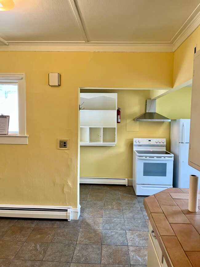 View of kitchen from hallway to bathroom. - 114 Buell St