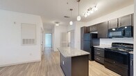 Located at 470 Bulldog Dr in Palm Coast, Florida, this well-designed 2-bedroom, 2-bathroom single-story home offers a practical and comfortable layout. The open-concept living, dining, and kitchen area serves as the heart of the home, featuring light wood-look flooring, crisp white walls, and a seamless flow throughout. The kitchen is appointed with dark espresso cabinetry, granite countertops, a center island with pendant lighting, a track light fixture, and black appliances, creating a functional and stylish workspace. A dedicated laundry area adds everyday convenience.

Both bedrooms are carpeted and feature ceiling fans, generous natural light from dual windows with outdoor views, and easy access to closet storage. Four closets total are distributed throughout the home, including well-organized walk-in style options with wire shelving systems. The primary bedroom connects directly to its own bathroom and offers two closets for added storage flexibility.

The two bathrooms are finished with light tile flooring, dark vanity cabinetry, and granite-topped sinks. One bathroom includes a tub-shower combo, while the other features a walk-in shower with grab bar. A central hallway connects all rooms efficiently, rounding out this thoughtfully laid-out home in a convenient Palm Coast location.