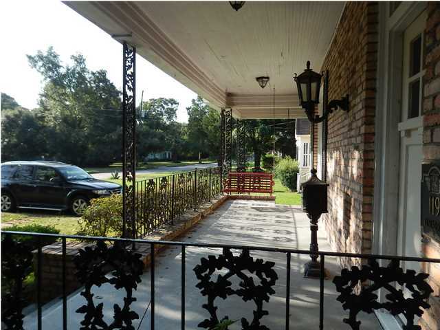 Front porch with ironwork railings and iron mailbox - 119 Tuscaloosa St