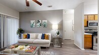 This one-bedroom, one-bathroom unit in Austin, TX offers a thoughtfully designed single-floor layout that maximizes its compact footprint. The living room serves as the heart of the space, featuring wood-style plank flooring, a ceiling fan, and a sliding glass door that floods the room with natural light while providing access to an outdoor patio. Neutral gray walls create a calm, cohesive backdrop throughout.

The galley-style kitchen is lined with warm wood cabinetry and equipped with black appliances, including a range and refrigerator. A louvered closet door adjacent to the kitchen conceals in-unit laundry. The dedicated dining area is defined by a pendant light overhead and a distinctive hexagonal moss wall accent, adding a natural, decorative element to the space.

The bedroom offers carpeted flooring, soft neutral tones, and a closet, providing a quiet and comfortable retreat. The full bathroom features warm wood cabinetry, a stone-topped vanity with a single sink, a large mirror, and a shower-tub combination. Wood-style flooring extends into the bathroom, maintaining a consistent aesthetic. Overall, the unit delivers a clean, modern ambiance with practical, well-organized living spaces.