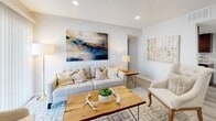 This single-floor residence at 4019 S 130th E Ave in Tulsa, Oklahoma, offers a thoughtfully designed layout with a clean, contemporary aesthetic. Light-toned luxury vinyl plank flooring runs throughout, providing a cohesive foundation that enhances the bright, airy atmosphere found in each room.

The living area is generously proportioned, featuring recessed lighting and a large sliding glass door covered by vertical blinds that allows natural light to pour in. The open layout comfortably accommodates multiple seating arrangements, making it well-suited for both relaxing and entertaining.

The galley-style kitchen is efficiently organized, featuring rich dark wood cabinetry, granite-look countertops, a stainless steel sink, and a full suite of stainless steel appliances including a range, microwave, and refrigerator. A decorative accent rug adds warmth to the light flooring underfoot.

Multiple bedrooms are present, each finished with soft neutral walls, light-filled windows with white blinds, and recessed or overhead lighting. The rooms offer comfortable proportions suitable for full or king-sized beds with accompanying furniture.

The bathroom is finished with marble-style tile in the tub and shower surround, complemented by dark wood cabinetry and granite-look countertops, consistent with the finishes found throughout the home. Overall, the residence presents a polished, move-in ready environment.