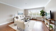 Located at 47 Legion Dr in Bergenfield, NJ, this well-appointed one-bedroom, one-bathroom residence offers a thoughtfully designed single-floor layout. Warm hardwood flooring runs throughout, creating a cohesive and inviting atmosphere across all rooms.

The living room is a bright, open space anchored by a large picture window fitted with white plantation shutters, allowing abundant natural light to fill the room. Crown molding along the ceiling adds a refined architectural touch throughout the home.

The kitchen is outfitted with crisp white shaker cabinetry, light quartz countertops, a subway tile backsplash, and a full suite of stainless steel appliances, including a range, microwave, dishwasher, and refrigerator — providing both style and functionality.

The spacious bedroom features a wide window with exterior views and continued crown molding, offering a serene and comfortable retreat. An adjacent walk-in closet includes a built-in shelving and hanging system, maximizing storage efficiency.

The bathroom is finished to a high standard, featuring marble-look tile walls, a frameless glass walk-in shower, a floating wood-toned vanity with a white basin, and a mirrored medicine cabinet — delivering a clean, contemporary aesthetic throughout.