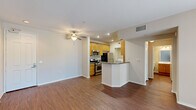 Located at 20455 Sorrento Lane in Los Angeles, CA, this one-bedroom, one-bathroom unit offers a well-organized single-floor layout designed for comfortable everyday living. The open-concept living and kitchen area forms the heart of the unit, featuring rich hardwood-style flooring, recessed lighting, and a ceiling fan. The kitchen is equipped with warm-toned wood cabinetry, stainless steel appliances including a gas range, microwave, and refrigerator, and a peninsula with a dark granite-style countertop that provides additional prep and dining space. The living area offers a clean, bright canvas with neutral walls and easy access to the rest of the unit. The bedroom is carpeted for comfort and features large windows dressed with blinds, allowing ample natural light and views of greenery outside. A sliding glass door in the living area also provides outdoor access and additional natural light. The bathroom includes a full tub and shower combination enclosed by sliding glass doors, built-in wall shelving, a vanity with wood cabinetry, and hardwood-style flooring. A dedicated in-unit laundry area accommodates a full-sized washer and dryer, adding significant everyday convenience to this efficiently designed home.