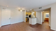 Located at 20455 Sorrento Lane in Los Angeles, CA, this one-bedroom, one-bathroom unit offers a well-organized single-floor layout designed for comfortable everyday living. The open-concept living and kitchen area forms the heart of the unit, featuring rich hardwood-style flooring, recessed lighting, and a ceiling fan. The kitchen is equipped with warm-toned wood cabinetry, stainless steel appliances including a gas range, microwave, and refrigerator, and a peninsula with a dark granite-style countertop that provides additional prep and dining space. The living area offers a clean, bright canvas with neutral walls and easy access to the rest of the unit. The bedroom is carpeted for comfort and features large windows dressed with blinds, allowing ample natural light and views of greenery outside. A sliding glass door in the living area also provides outdoor access and additional natural light. The bathroom includes a full tub and shower combination enclosed by sliding glass doors, built-in wall shelving, a vanity with wood cabinetry, and hardwood-style flooring. A dedicated in-unit laundry area accommodates a full-sized washer and dryer, adding significant everyday convenience to this efficiently designed home.