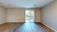 Located at 2723 S Topeka St in Wichita, KS, this well-organized unit makes smart use of its cozy footprint across a single floor. The combined kitchen and living room serves as the heart of the space, featuring warm wood-look plank flooring that flows throughout the entire unit. The living area is bright and open, with neutral beige walls and a sliding glass door fitted with vertical blinds that leads to a private balcony, offering views of surrounding greenery and filling the room with natural light. A ceiling fan with light fixture adds both function and comfort to the space.

The galley-style kitchen is efficiently designed, featuring white cabinetry, light granite-look countertops, a stainless steel refrigerator, and a black electric range. The layout maximizes counter and storage space within a narrow, well-lit corridor. Adjacent to the kitchen, a hallway connects the living areas to the rest of the unit and includes closet storage.

The bathroom is clean and functional, equipped with a full soaking tub surrounded by crisp white tile surround with a built-in ledge, a vanity with a white cabinet and sink, and a toilet. The consistent wood-look flooring and neutral color palette throughout the unit create a cohesive, modern aesthetic that feels clean and move-in ready.