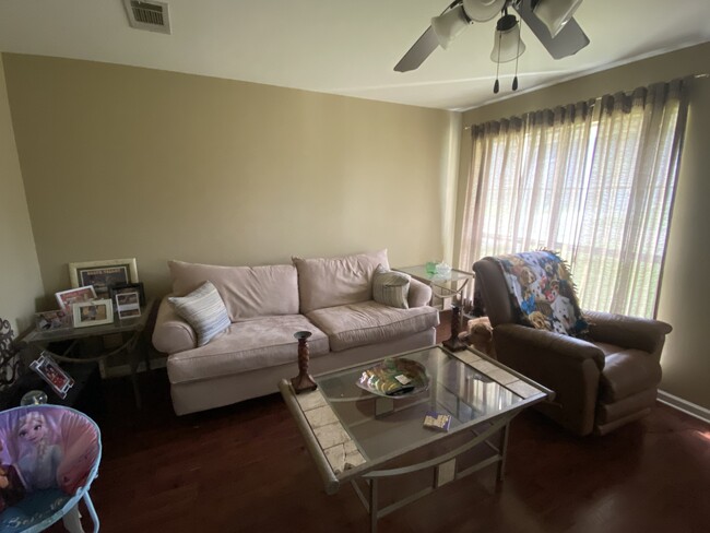 Fully furnished living room featuring a suede couch. - 12461 Havenwood Dr