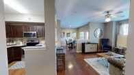 Located at 11400 Space Center Blvd in Houston, TX, this thoughtfully designed one-bedroom, one-bathroom residence offers a comfortable and functional single-floor layout. Rich hardwood flooring flows through the open-concept living, dining, and kitchen areas, creating a cohesive and inviting atmosphere. The living room features large windows that flood the space with natural light, a ceiling fan, and ample room for seating. It connects seamlessly to a defined dining area, which includes a charming window view and decorative wall accents. The kitchen is well-equipped with dark espresso cabinetry, granite-style countertops, stainless steel appliances including a side-by-side refrigerator, electric range, and microwave, plus a breakfast bar with seating. A dedicated pantry adds valuable storage. The spacious primary bedroom offers plush carpeting, a ceiling fan, natural light from a window, and access to two closets. The full bathroom features tile flooring, a dark vanity with granite countertops, and a shower-tub combination. Additional conveniences include an in-unit laundry area and a hallway connecting all rooms. The warm, neutral color palette and modern finishes throughout give this residence a polished, move-in-ready feel.