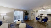 This single-floor residence offers a thoughtfully designed layout with a cohesive blend of comfort and style. The living room serves as the heart of the home, featuring crown molding, wood-look flooring, and a fireplace that anchors the space. Large sliding glass doors with vertical blinds open to a private patio, allowing natural light to flow freely throughout. The living area connects seamlessly to a dedicated dining space, which features a ceiling fan, crown molding, and warm wood-look flooring.

The galley-style kitchen is efficiently arranged with white cabinetry, light countertops, black appliances including a range and refrigerator, and ample upper and lower storage. Crown molding adds a polished finish to the space.

The primary bedroom offers plush carpeting, a ceiling fan, and generous closet access, while a secondary bedroom also features carpet flooring, a ceiling fan, and a window for natural light. The full bathroom is clean and functional, featuring a tub-shower combination with tile surround and wood-look flooring. A dedicated laundry area with a full-size washer and dryer completes this well-rounded residence.